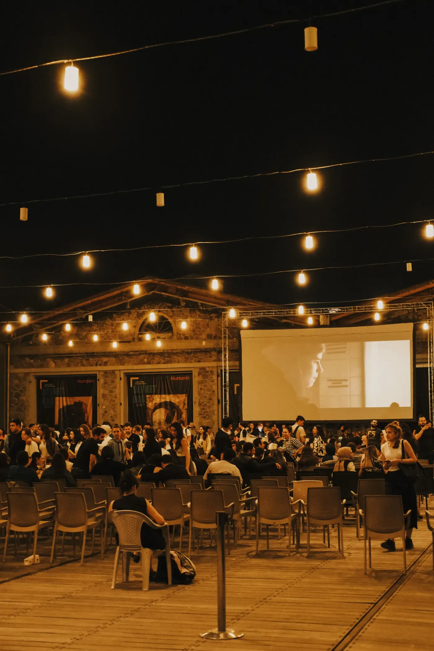 An evening industry event with a seated audience watching a presentation