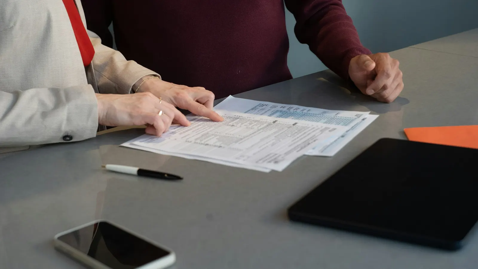 Two people reviewing documents together at a table